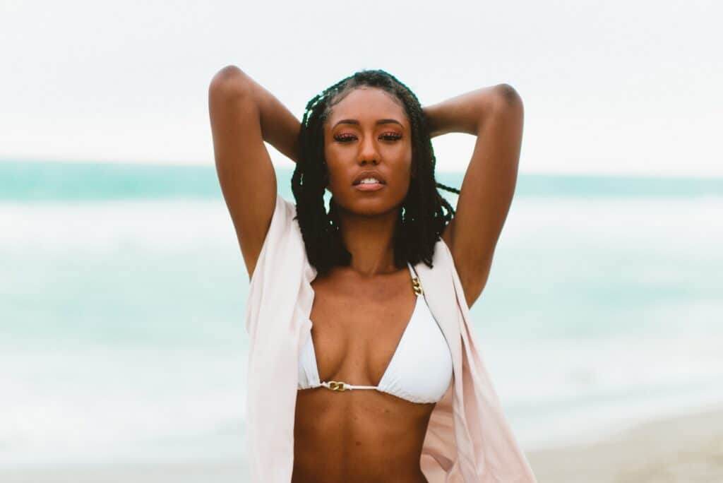 A woman wearing a white bikini on a beach