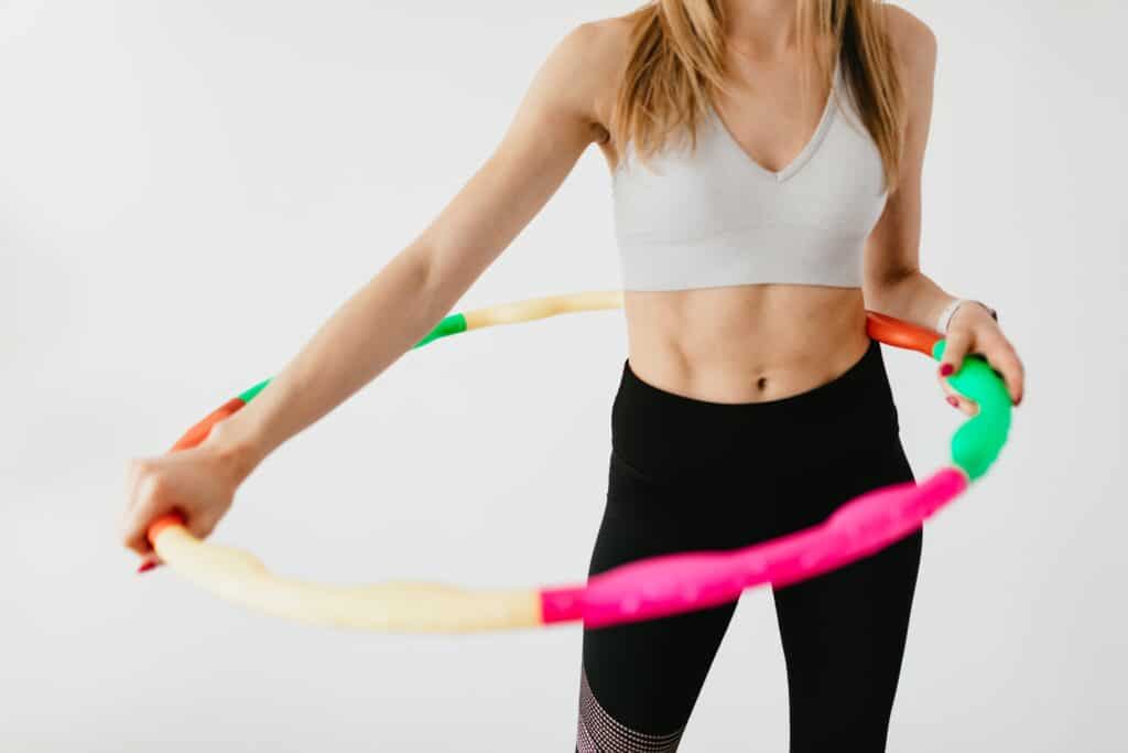 A person wearing leggings with a hulahoop