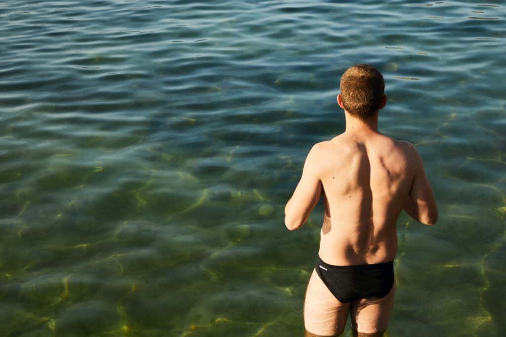 a man standing wearing a black underwear