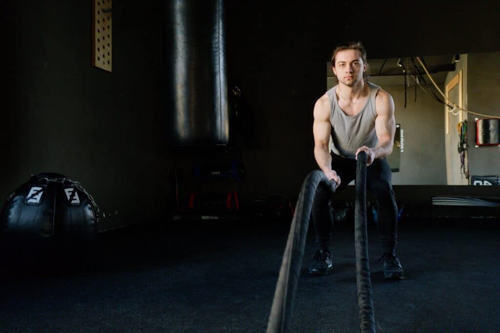 a man holding a rope wearing a black leggings