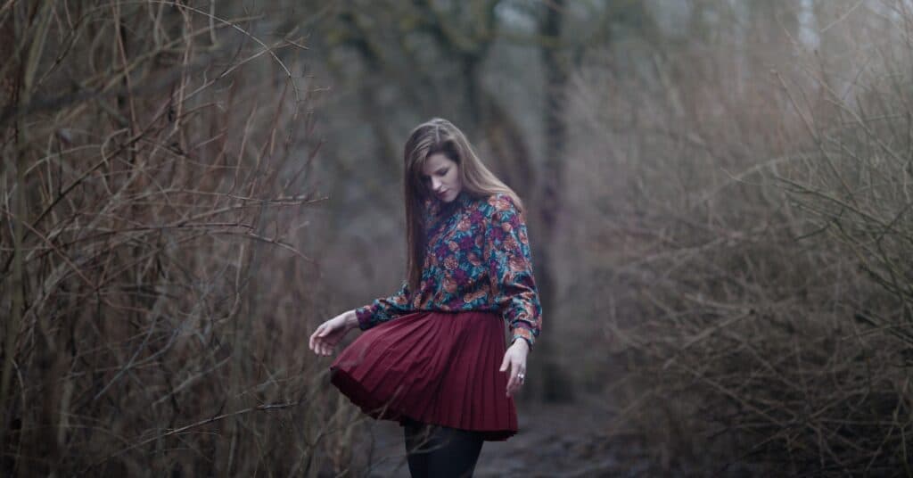 A woman wearing a red skirt with leggings