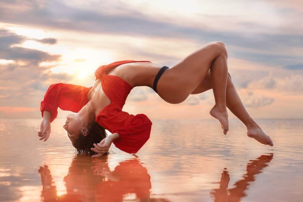 a woman bending her back wearing a bikini