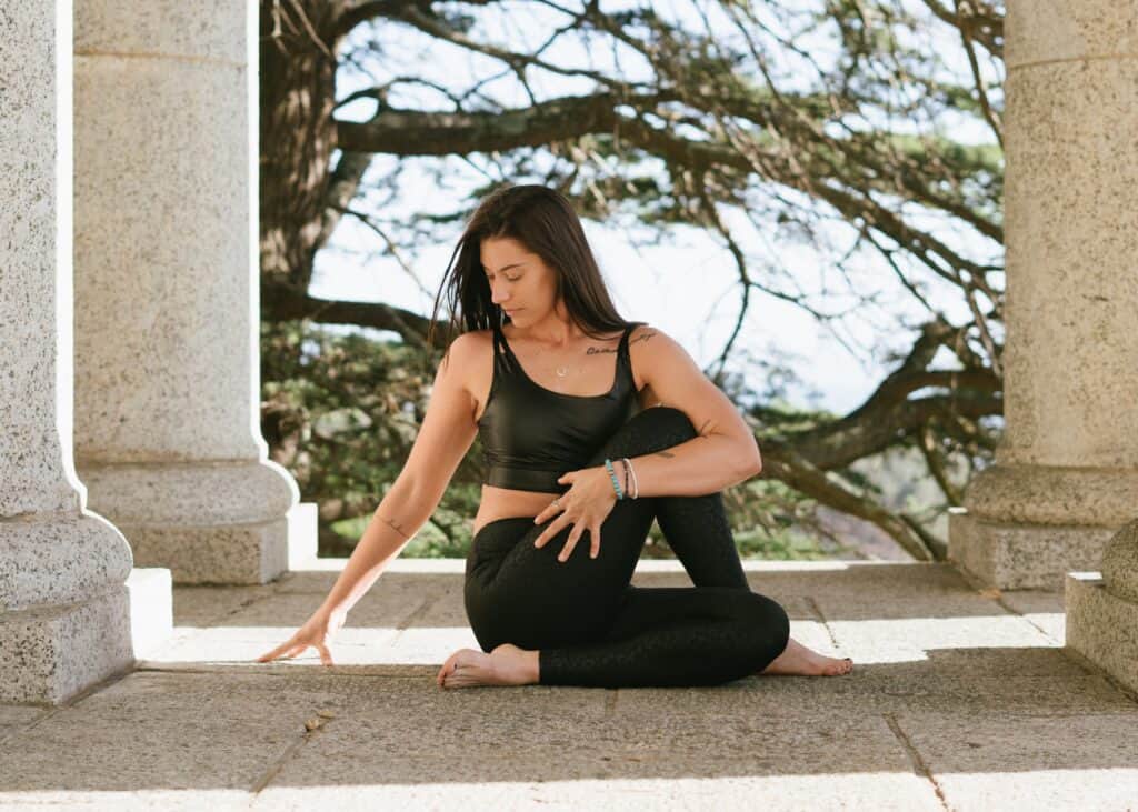 a woman stretching wearing a black leggings