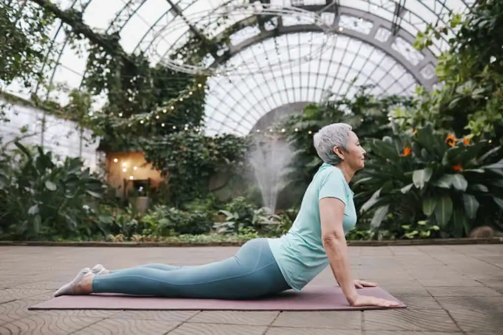 an old woman stretching wearing leggings