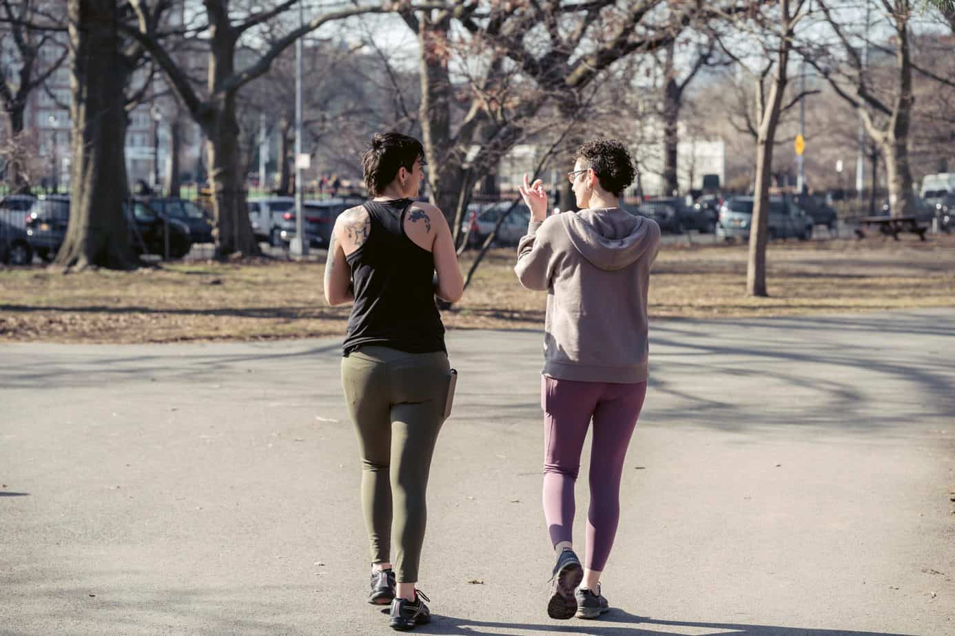 Two people walking wearing leggings