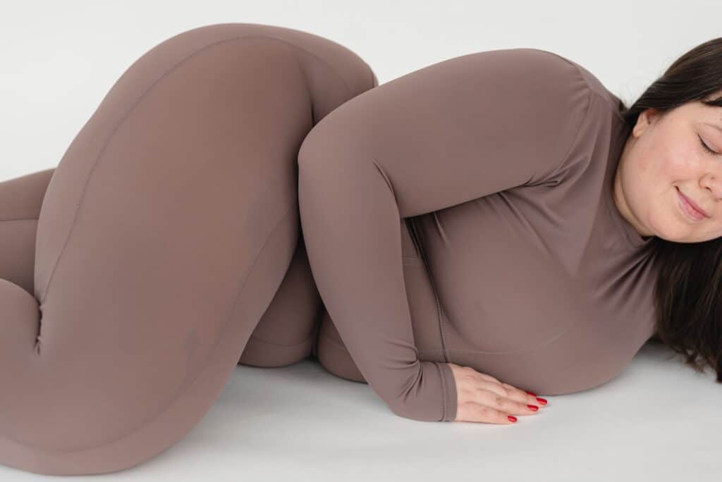 a woman lying on the floor wearing a plus size leggings