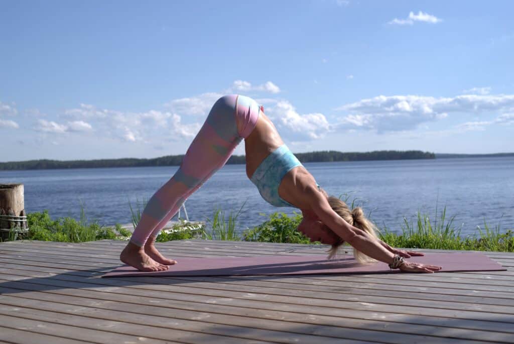 a woman doing yoga wearing printed leggings