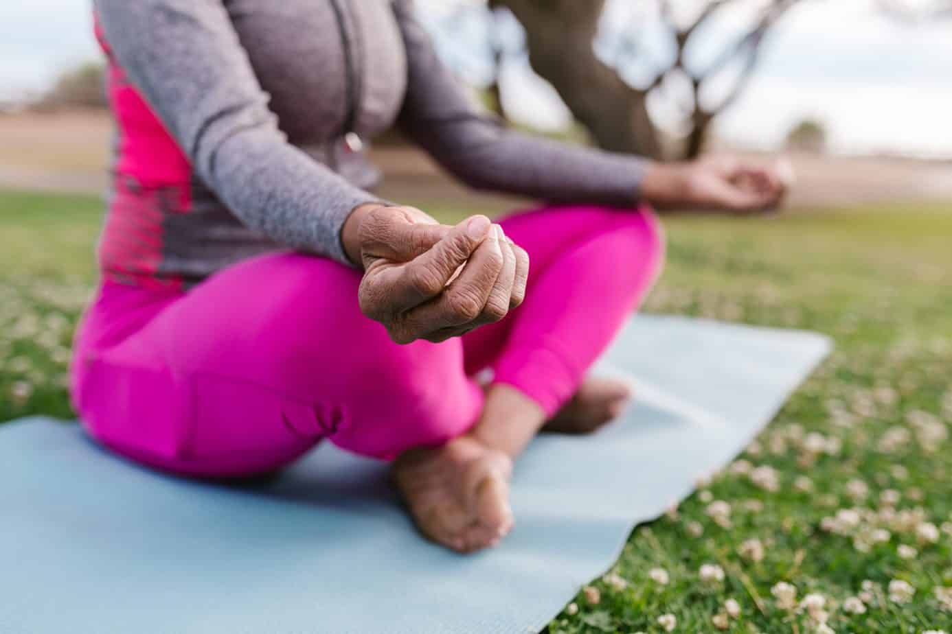 a woman on a yoga pose wearing a pink leggings