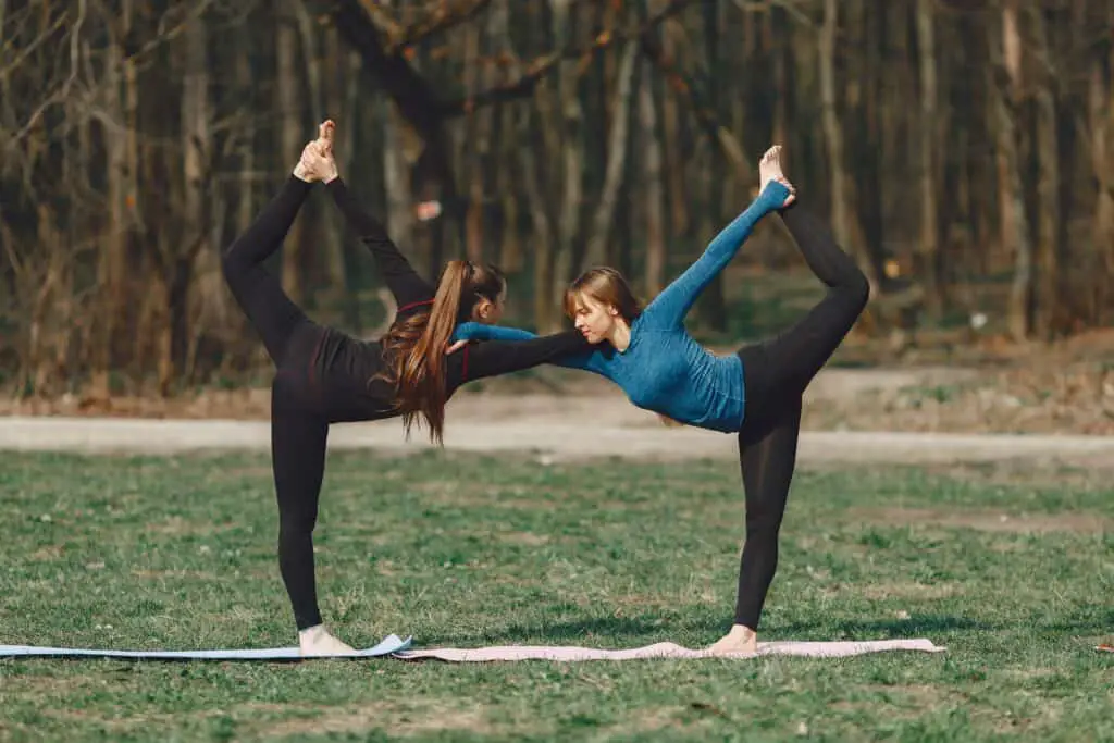 two women with the same pose wearing black leggings