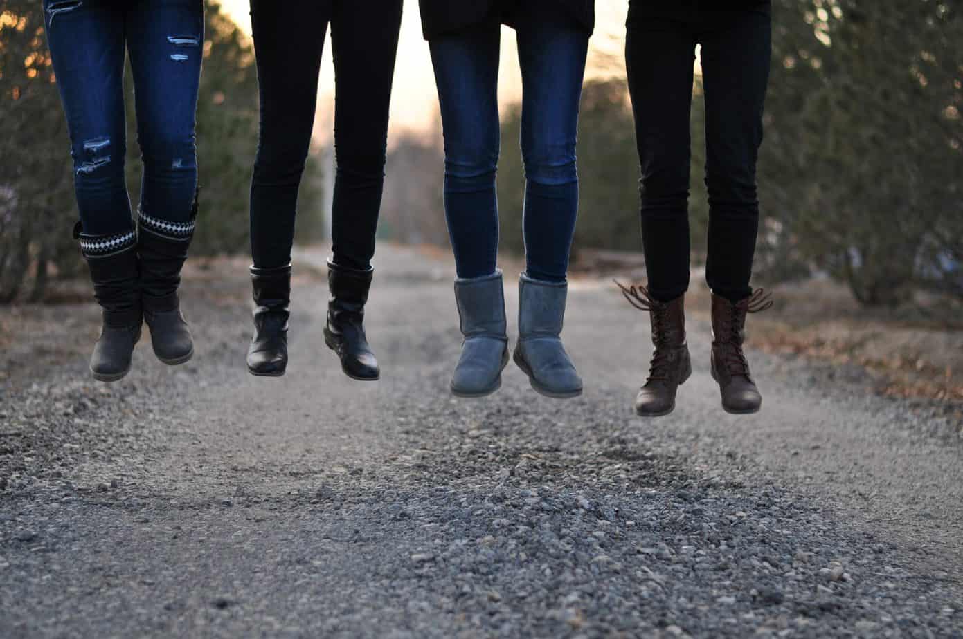 four people wearing leggings and jeans
