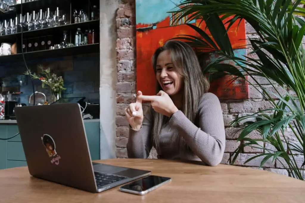 a woman smiling while on a zoom meeting