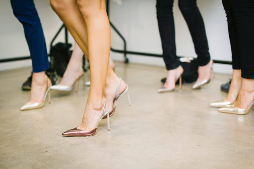 group of women wearing leggings with heels