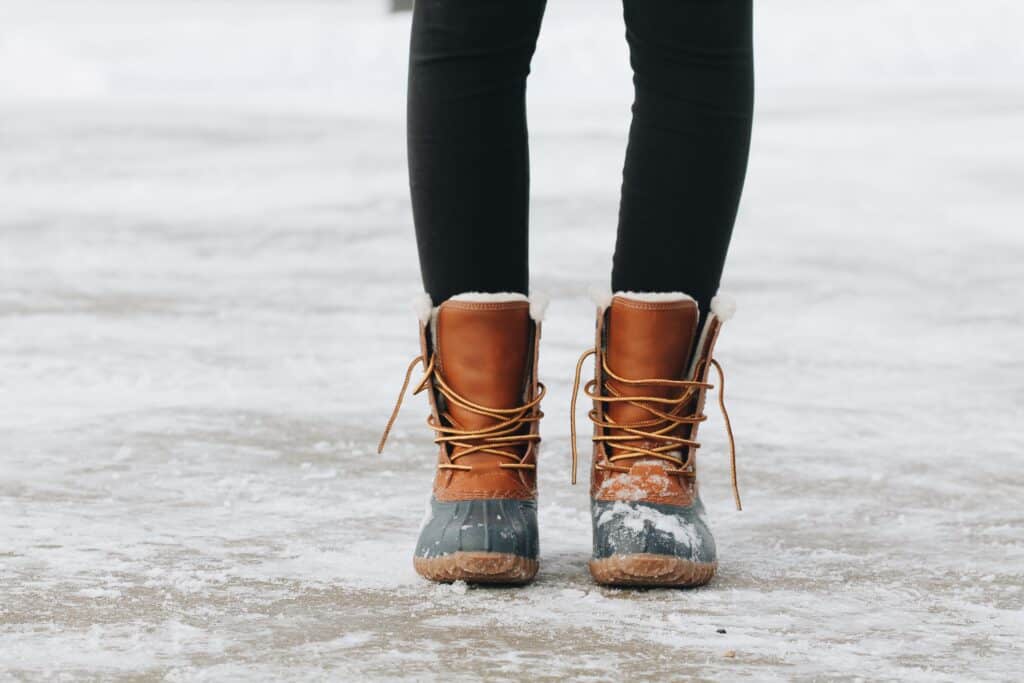 a person wearing black leggings with boots