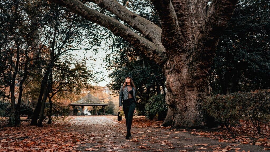 a woman walking wearing leather leggings