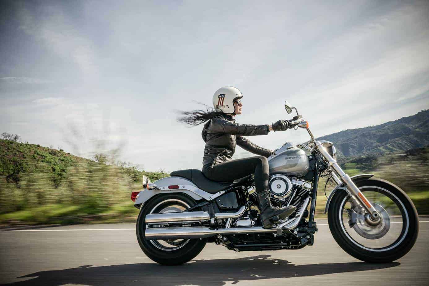 A woman wearing leather leggings on a motorbike
