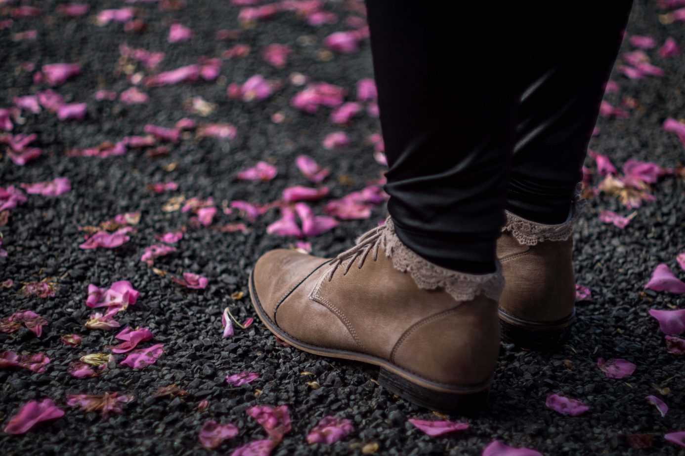 a person wearing a leather leggings with leather shoes