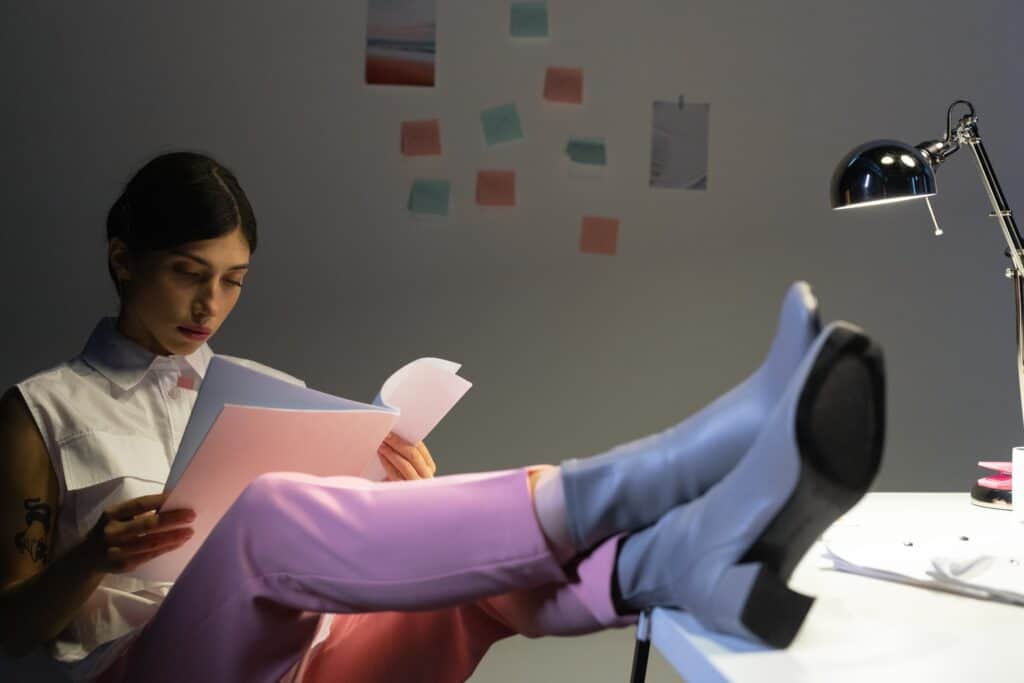 a person reading wearing a pink velvet leggings