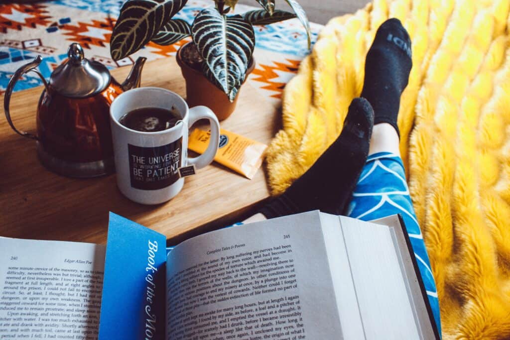 a person reading a book wearing a printed velvet leggings