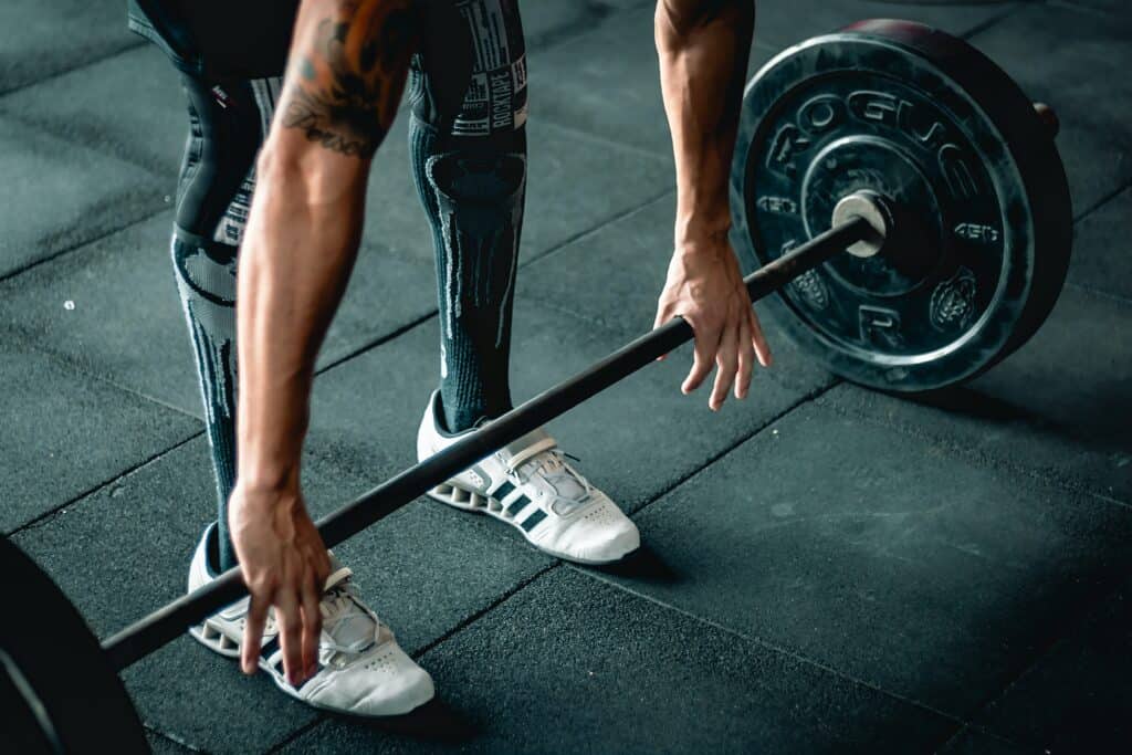 a person lifting barbell wearing leggings