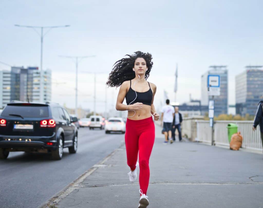 a girl running on the street wearing leggings