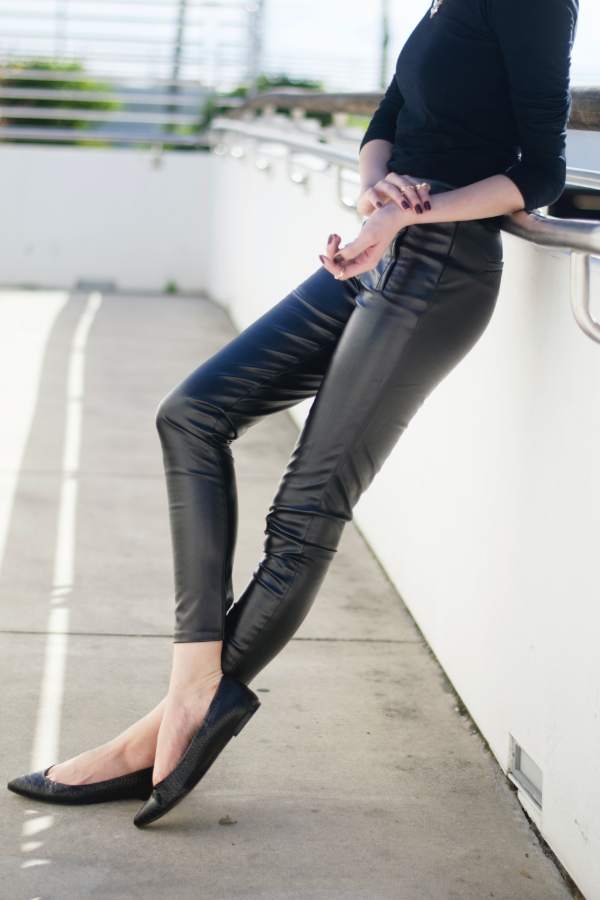 Woman wearing black leather leggings