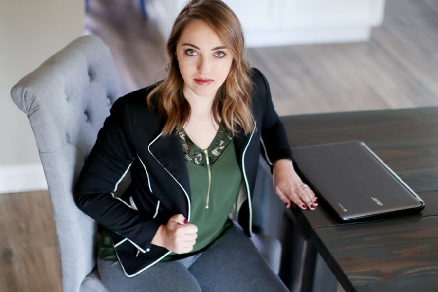 Woman wearing a black blazer and gray leggings