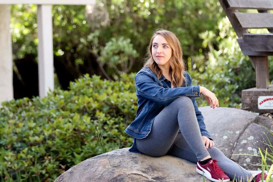 A woman sitting on a big rock