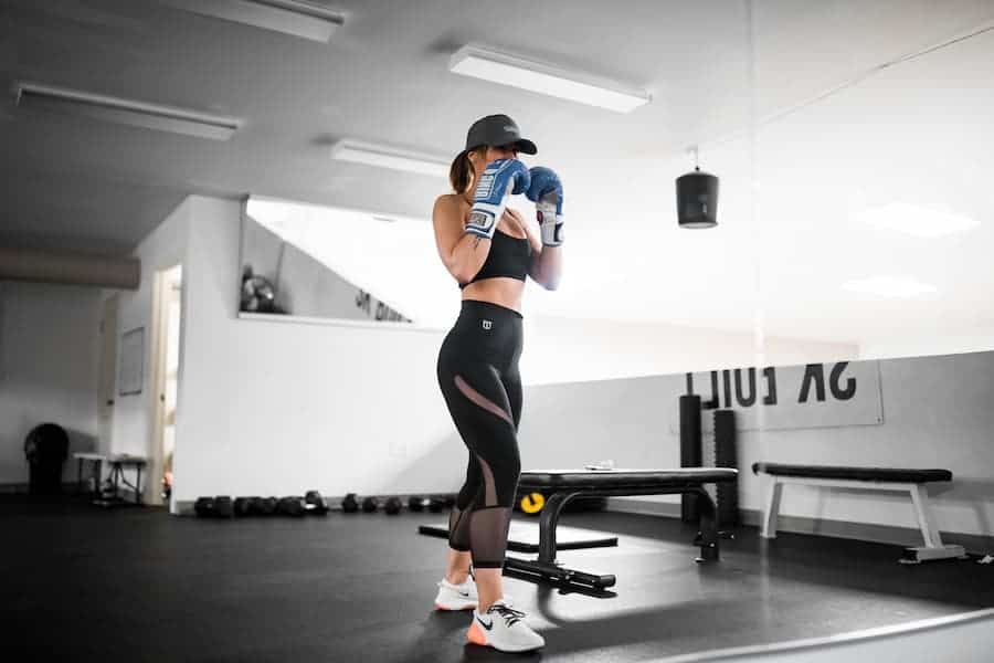 Woman wearing fit leggings and boxing gloves