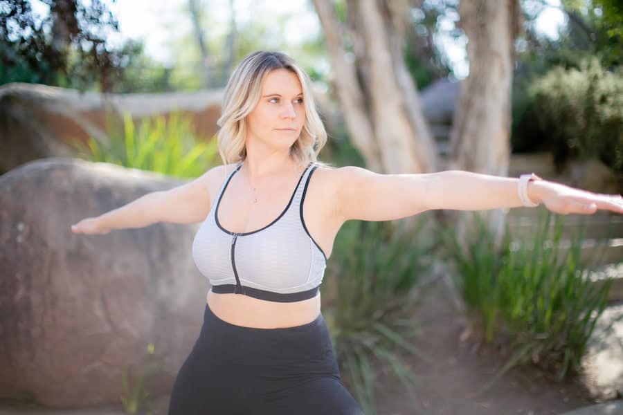 A woman doing yoga poses while wearing yoga pants