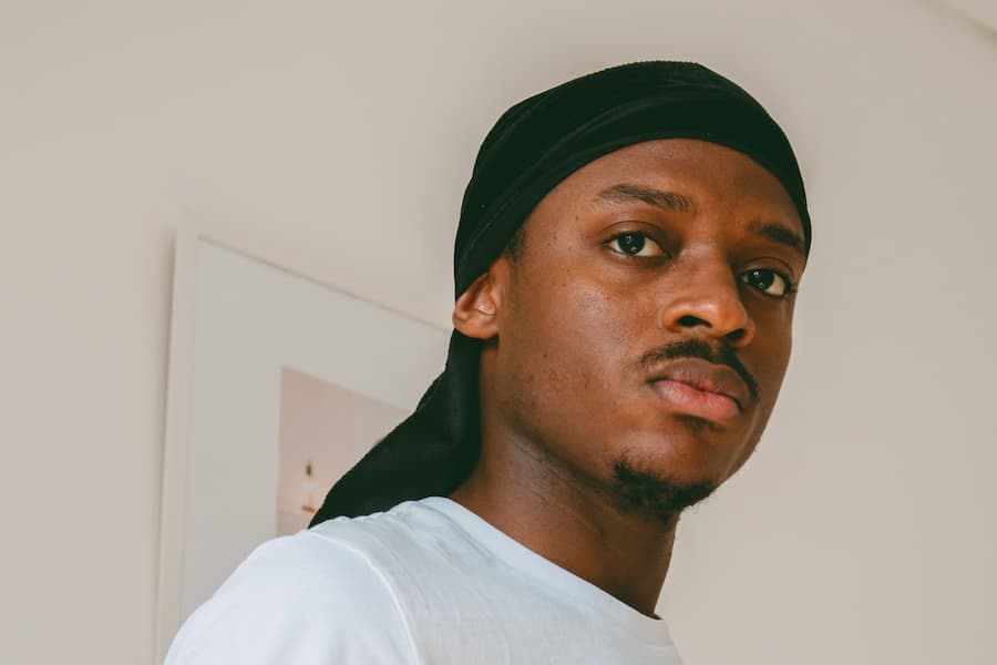 Close-up shot of a man wearing wave cap