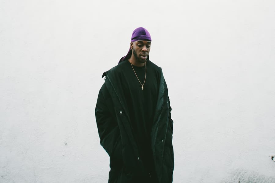 A man wearing violet wave cap