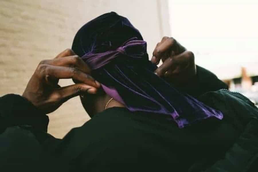 Man fixing his durag on his head