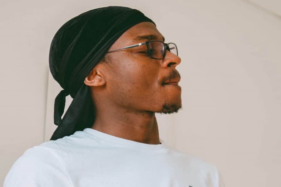 Man wearing eyeglasses and durag