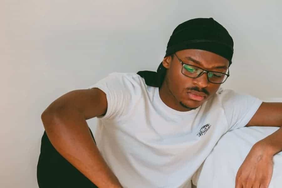 Man wearing black durag and an eyeglasses