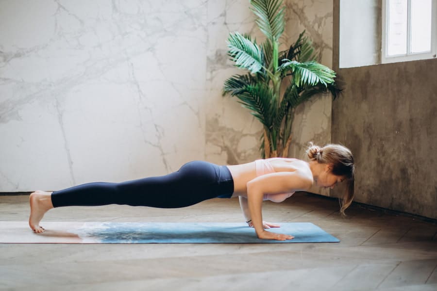 A woman doing yoga wearing leggings