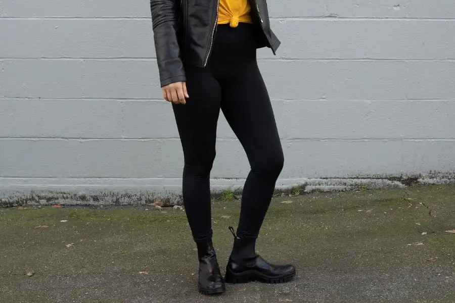 An image of a person wearing a leather jacket, leggings, and boots