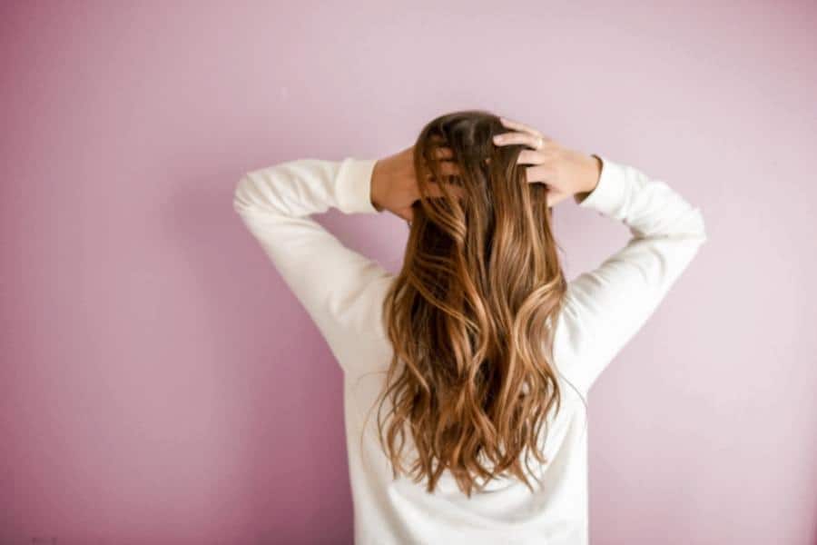 An image of a girl fixing her hair