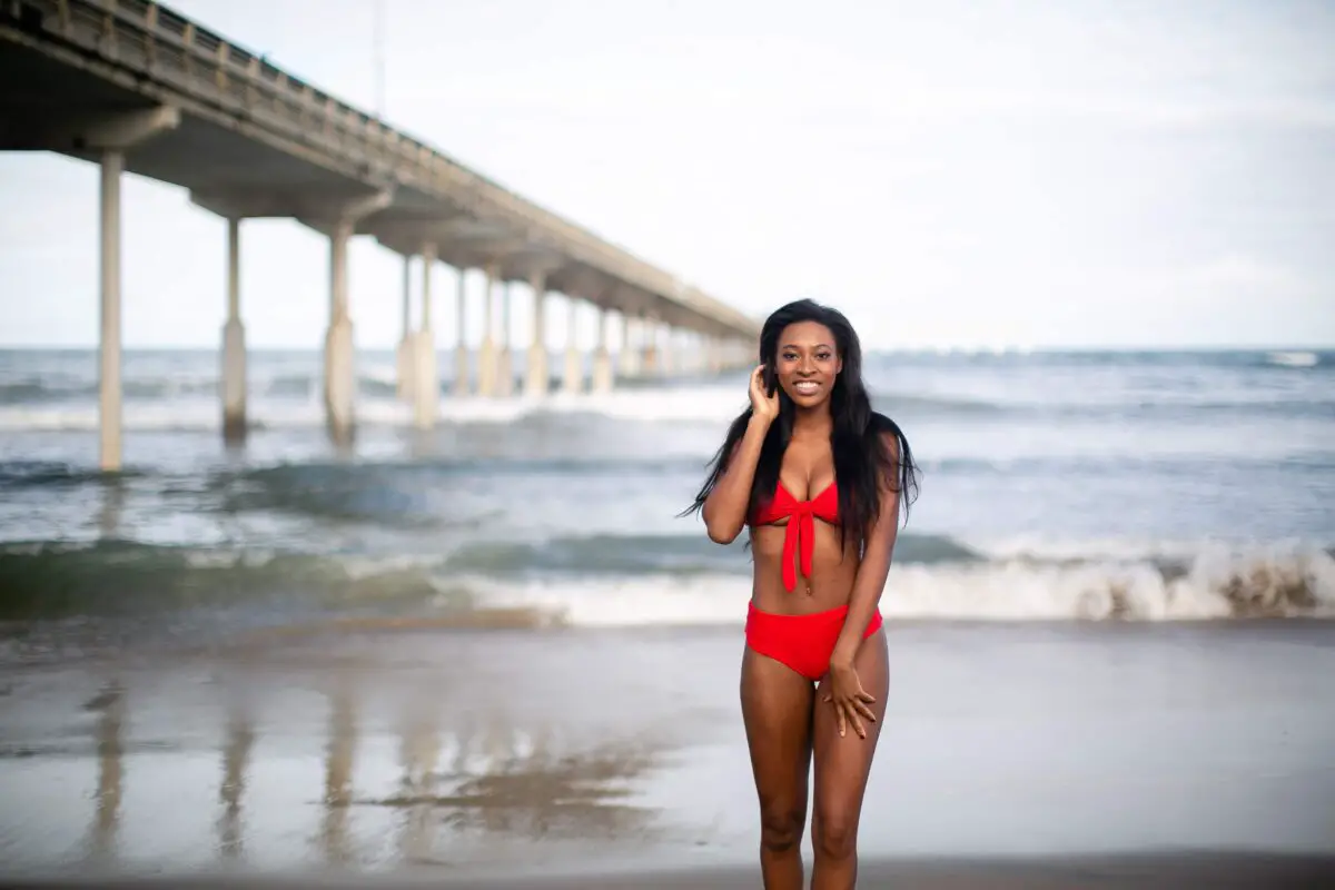 Woman wearing a red bikini standing near the beach